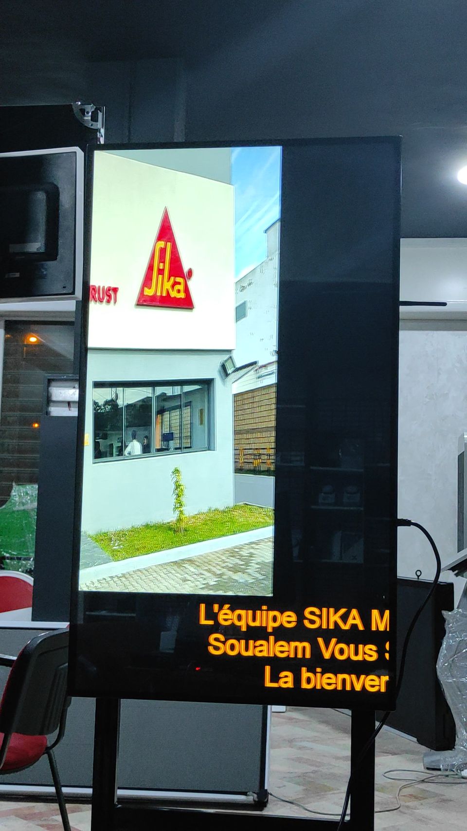 Vertical digital signage screen with scrolling welcome message