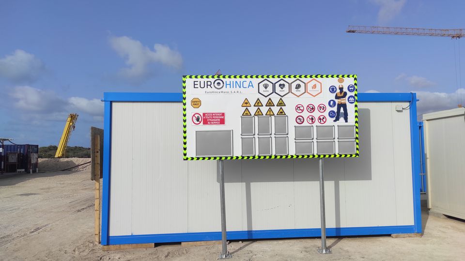 Construction-site HSE board with LED counters and safety pictograms