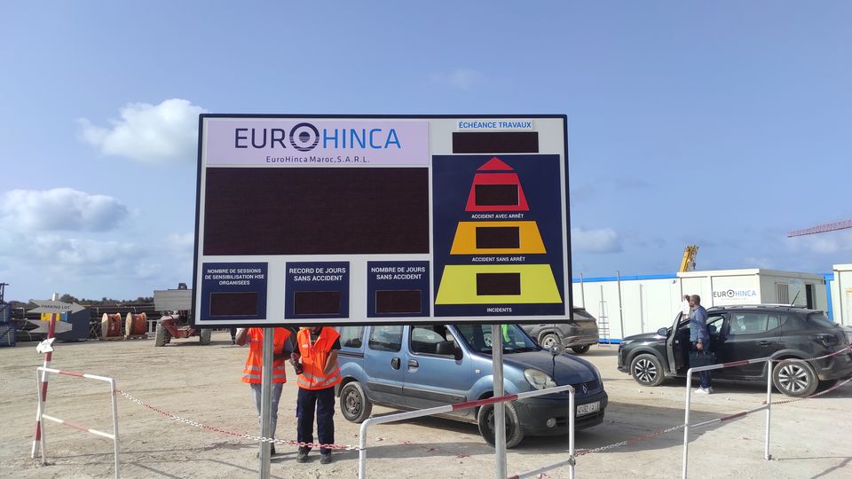 Construction-site HSE board with LED counters and safety pictograms